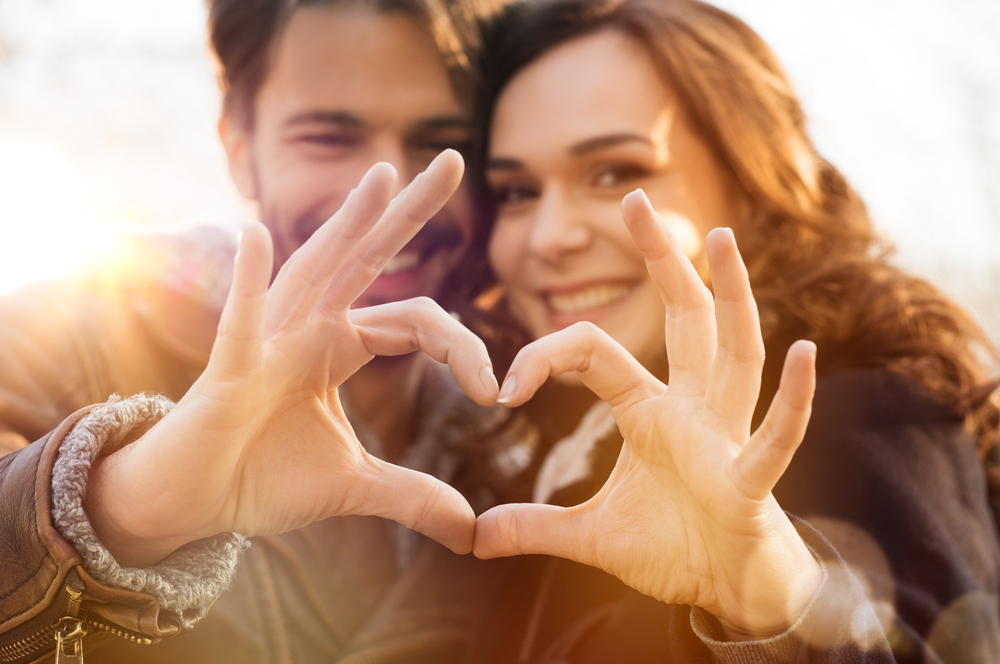 how to find love; couple in love make heart with hands