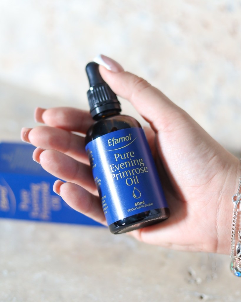 hand holding Efamolยฎ NEW Evening Primrose Oil Dropper